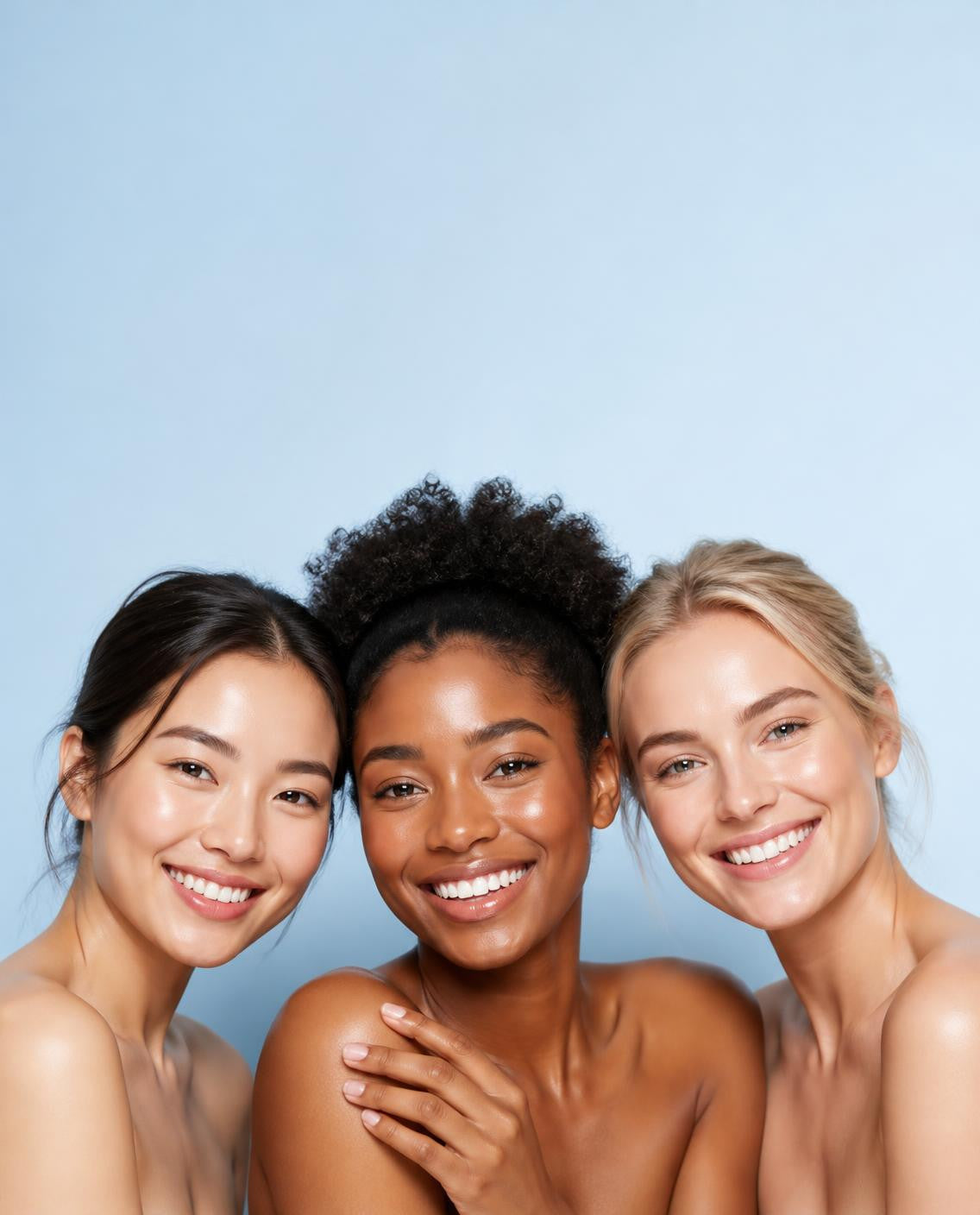 Three smiling women with glowing skin